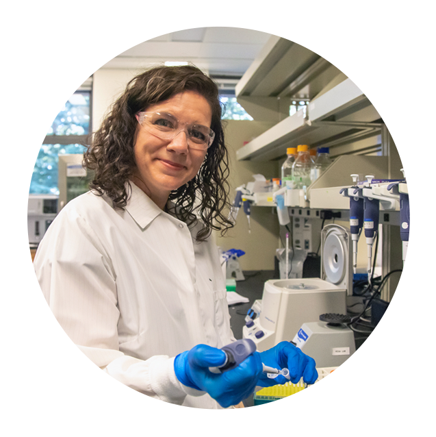Decorative image: scientist wearing white lab coat and blue gloves