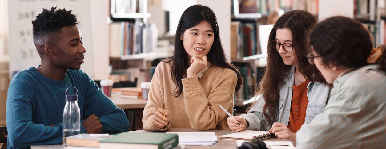 Decorative: A group of students sitting at a table.